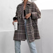 Oversized houndstooth cocoon coat in black and white with a notched lapel and relaxed fit.