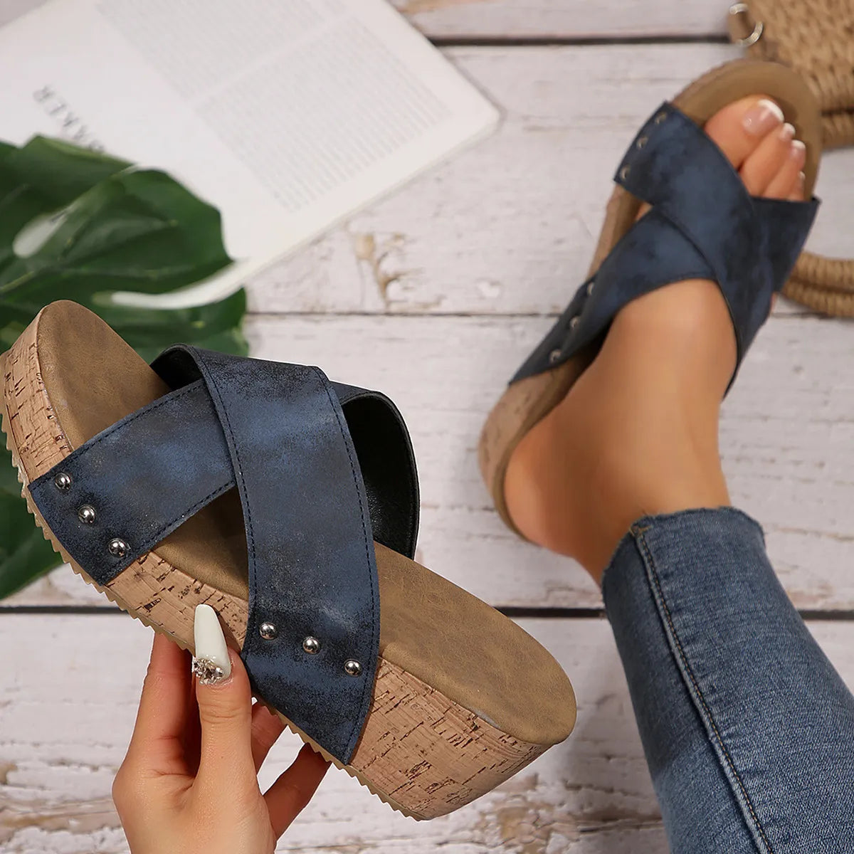 Navy crisscross studded cork wedge slides with a comfortable cork sole.