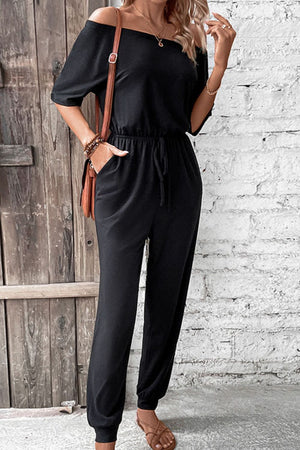 Black off-shoulder jumpsuit with drawstring waist and cuffed ankles