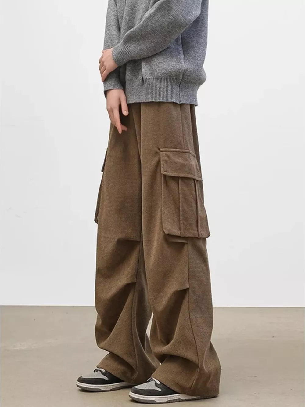 Brown cargo pants with multiple utility pockets and a relaxed fit.