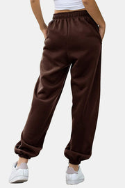 Relaxed-fit cuffed sweatpants in chocolate brown with elastic waistband and cuffs.