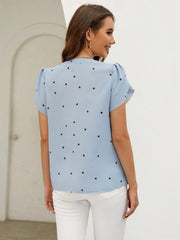 Light blue heart print blouse with puff sleeves and a V-neckline.