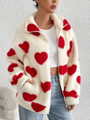 Cream sherpa zip-up jacket with red heart print and a collared neckline.