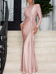 Pink ruched long sleeve maxi dress with boat neckline and bodycon fit.