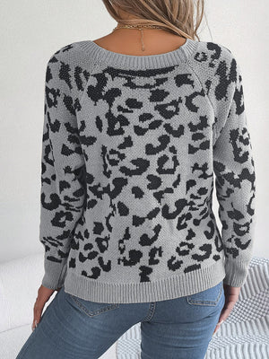 Leopard print sweater in charcoal acrylic with crewneck and button detail.