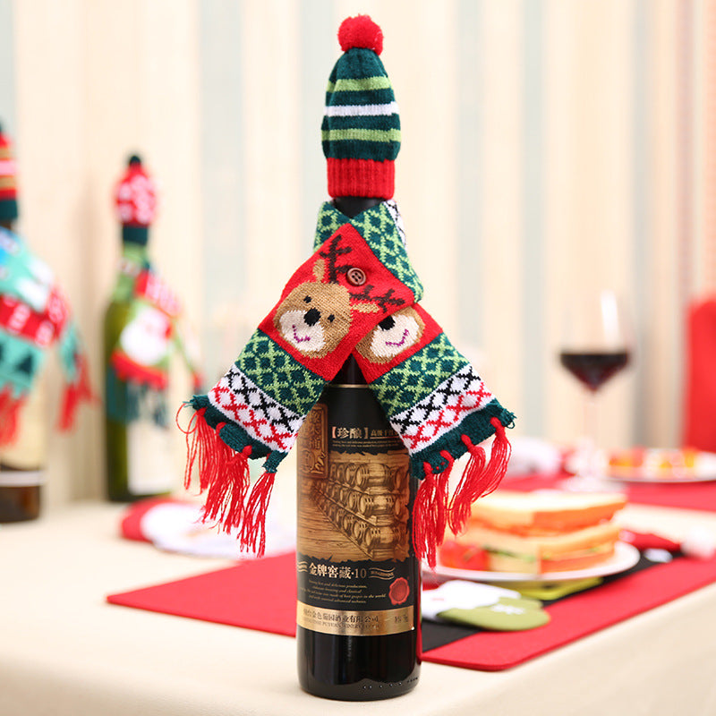 Holiday knit bottle dress with reindeer scarf and striped hat, red fringe details.