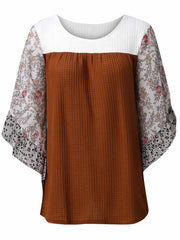 Textured panel blouse with floral flutter sleeves and round neckline.