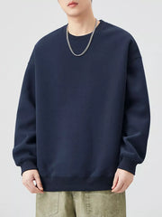 Navy blue oversized crew-neck sweatshirt with ribbed cuffs and hem.