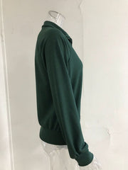 Green ribbed knit trench coat with a collar and long sleeves.