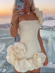 Cream ruffled one-shoulder mini dress with fitted bodice and voluminous skirt detail.