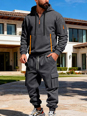 Men's dark gray half-zip hoodie and cargo pants set with orange accents.