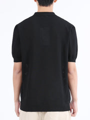 Black textured knit polo shirt with classic collar and short sleeves.