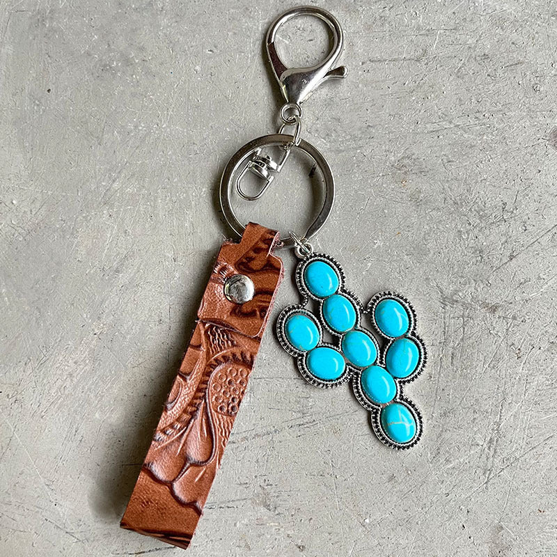 Tooled leather keychain with turquoise cross charm and silver hardware