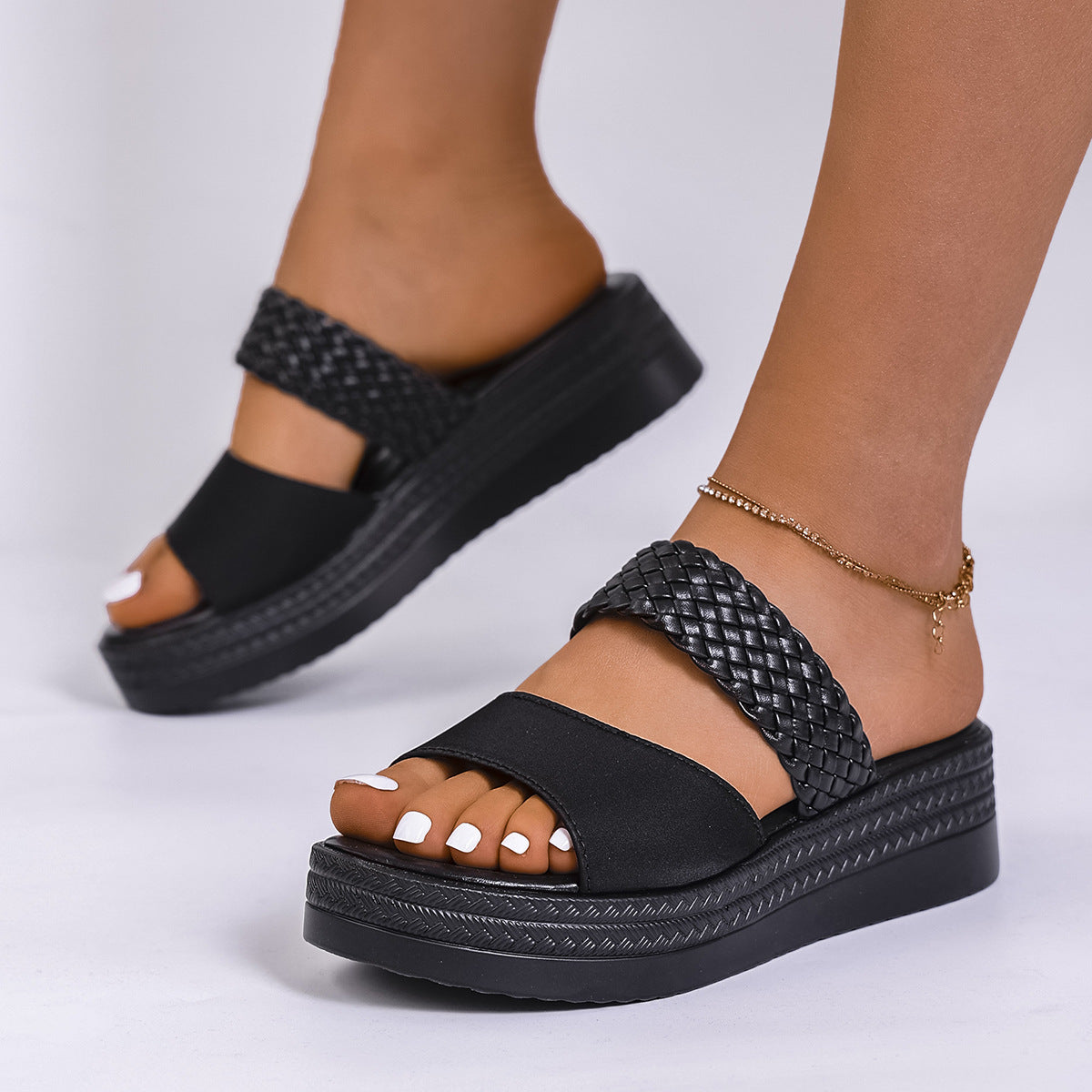 Chic black two-strap platform sandals with braided detail and chunky sole.