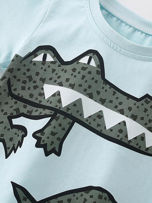 Light blue cotton toddler tee with a large green crocodile graphic and white teeth.