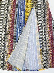 Bohemian maxi dress with colorful vertical stripes and a high slit.