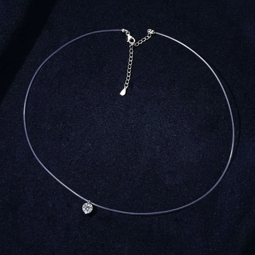 Silver floating moissanite necklace with clear wire and adjustable chain.