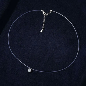 Silver floating moissanite necklace with clear wire and adjustable chain.