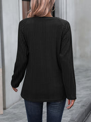 Black ribbed knit raglan sweater with long sleeves and button trim detail.