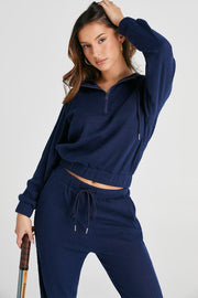 Navy ribbed crop hoodie with quarter zip and matching jogger pants with drawstring waist.