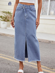 Light wash denim midi skirt with asymmetric front slit and frayed hem.