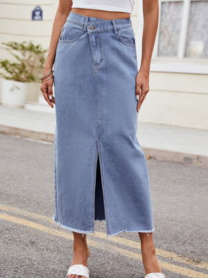 Light wash denim midi skirt with asymmetric front slit and frayed hem.