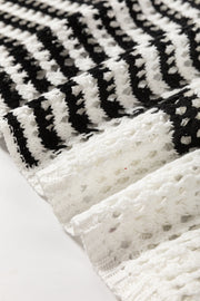 Graphic stripe crochet knit pullover in white and black acrylic with open knit detail.