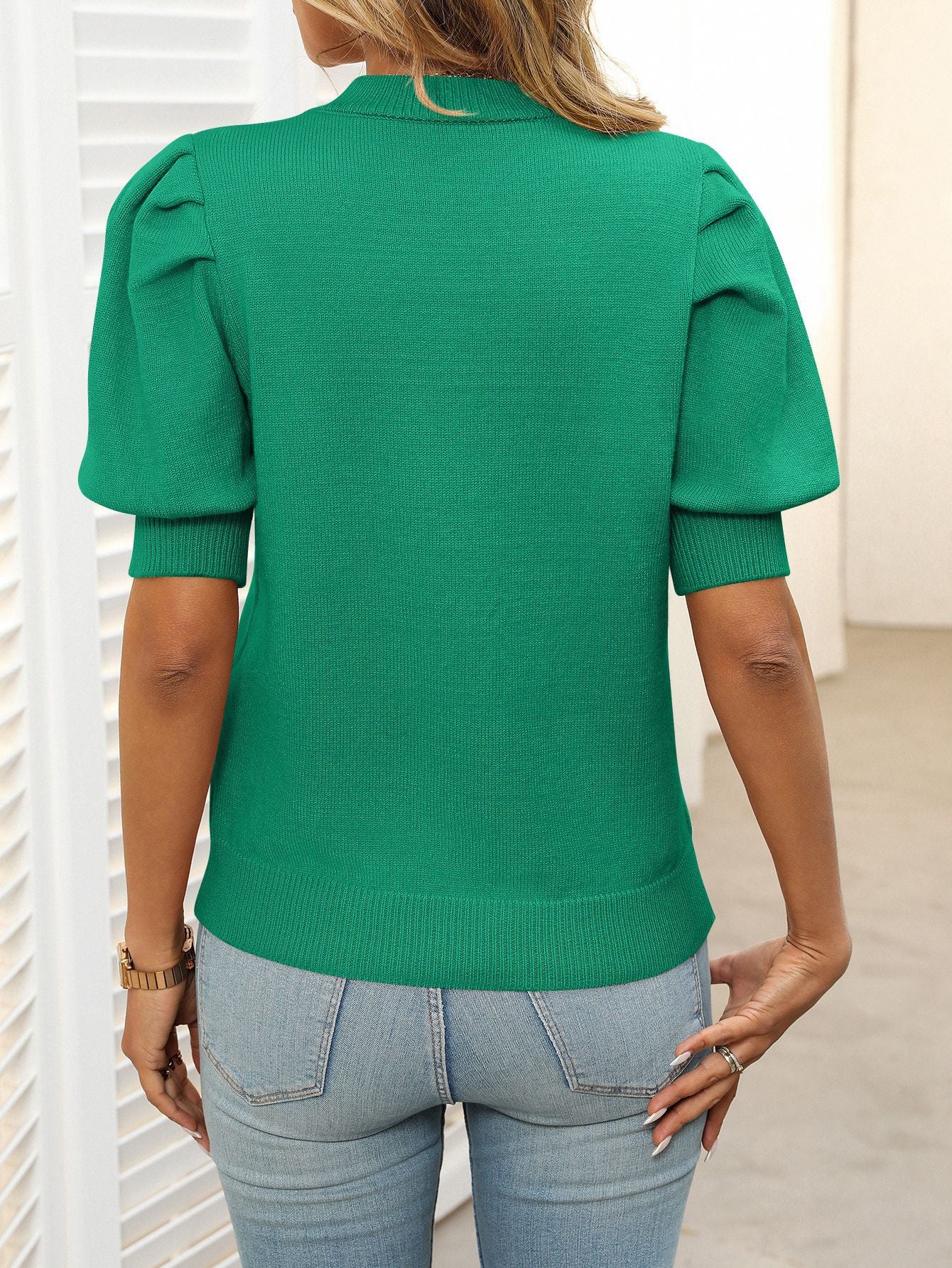 Green knit sweater with mock neck and puff sleeves, ribbed cuffs and hem