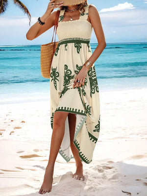 Cream maxi dress with smocked bodice, square neck, green print, and tiered hem.