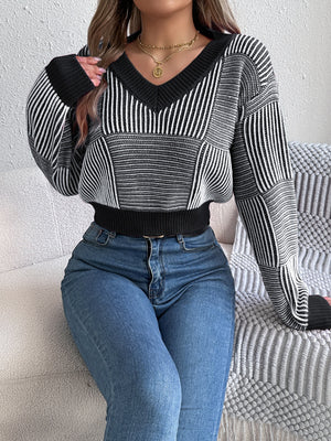 Black and white geometric stripe cropped V-neck knit sweater with ribbed cuffs and hem.