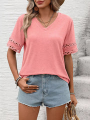 Pink V-neck t-shirt with lace trim on sleeves.