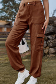 Brown cargo pants with multiple pockets and cuffed ankles.