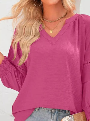Elegant smocked long sleeve blouse in Rose Purple polyester with V-neck and cinched cuffs.
