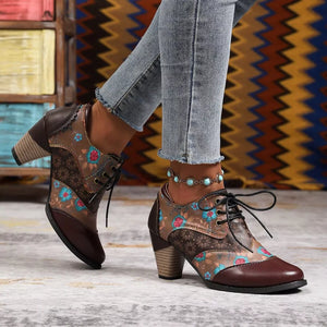 Floral patchwork lace-up ankle boots in dark brown with blue and red floral accents and a stacked heel.