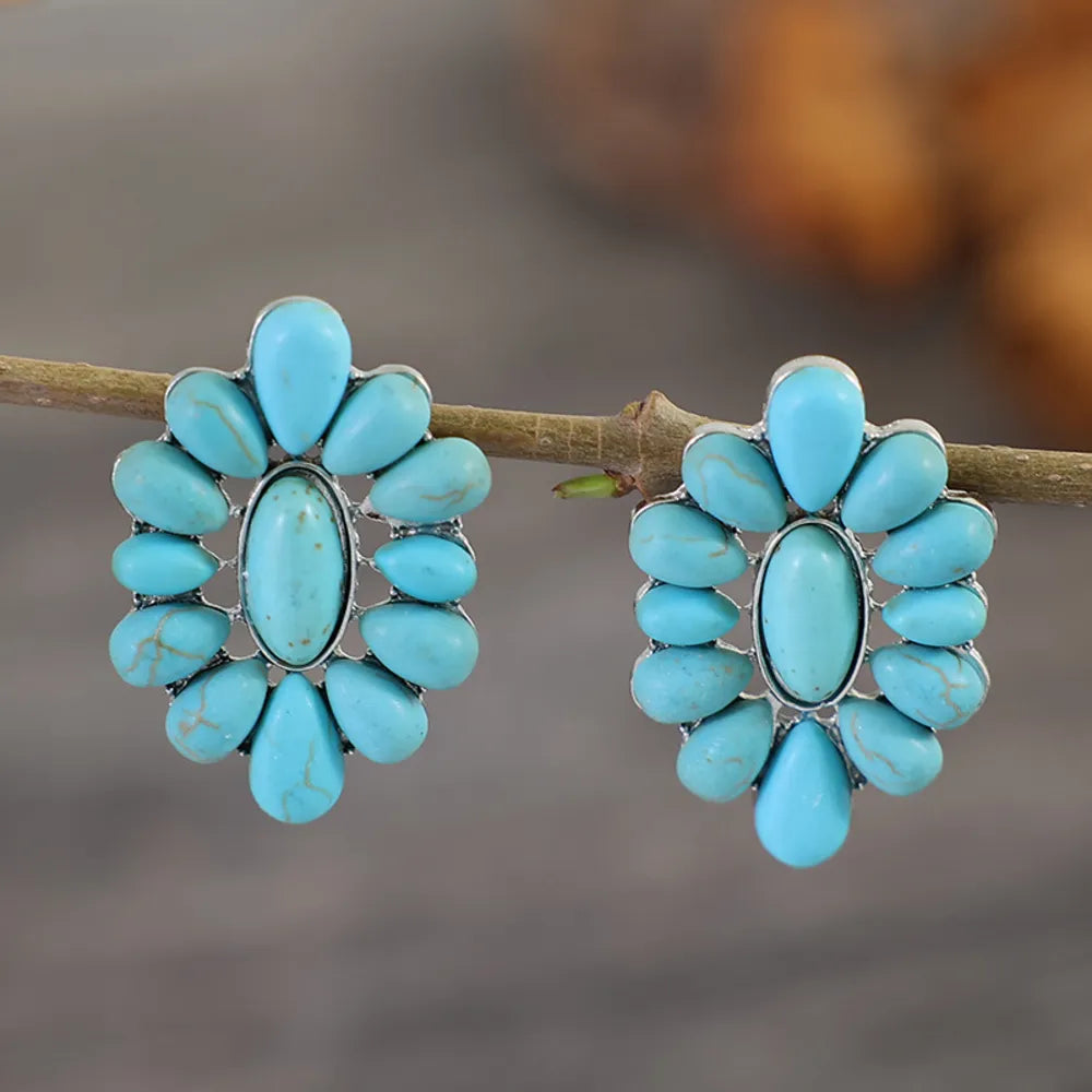 Turquoise petal stud earrings in silver with teardrop accents.