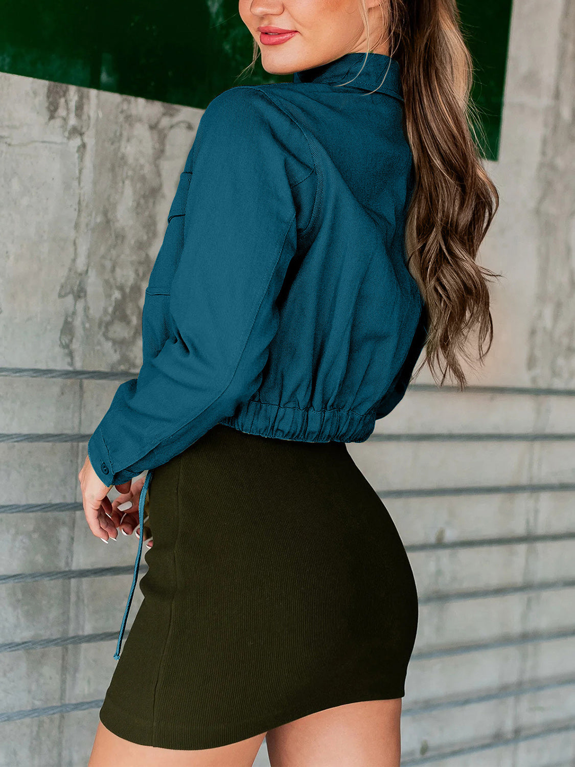 Peacock blue cropped utility jacket with drawstring hem and buttoned cuffs.