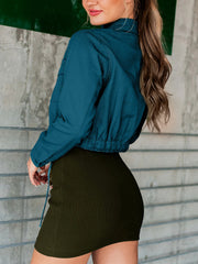 Peacock blue cropped utility jacket with drawstring hem and buttoned cuffs.