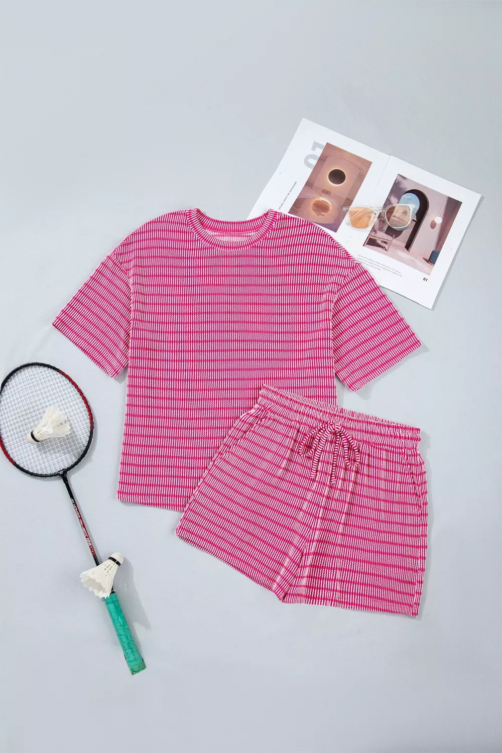 Fuchsia pink striped two-piece short set with drawstring shorts and crew neck top.