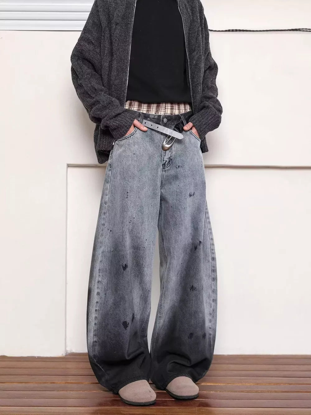 Men's washed wide leg jeans in faded grey with black splatters and distressed details.