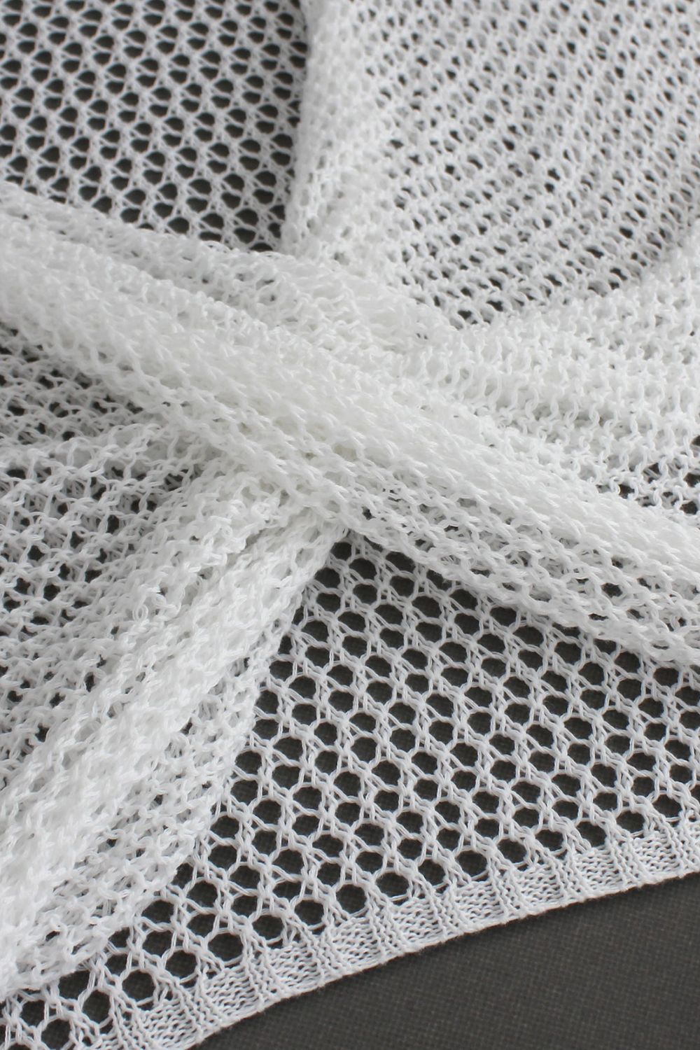 White crochet blouse with open knit detail and pearl chain accent
