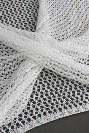 White crochet blouse with open knit detail and pearl chain accent