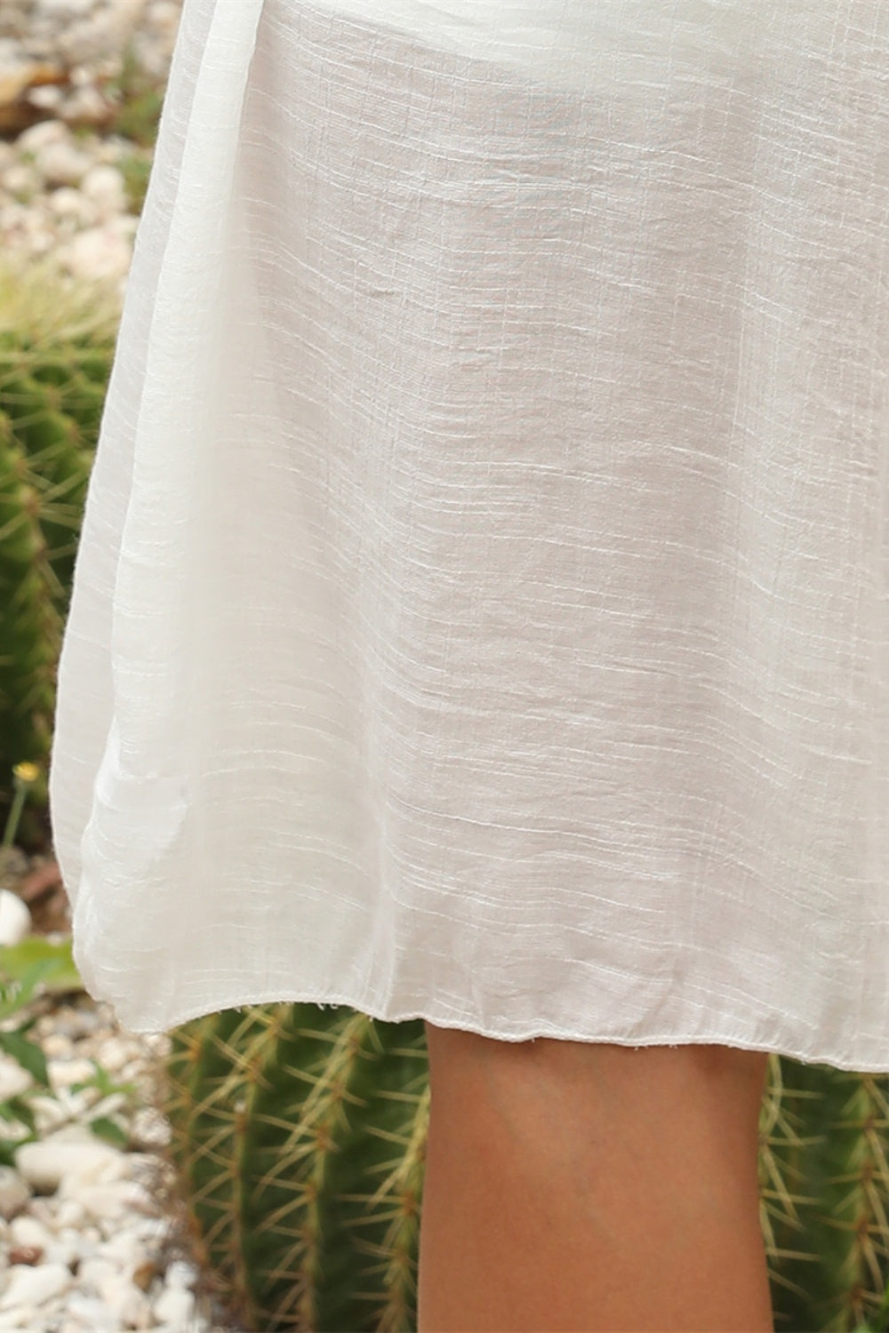 White crochet yoke cover-up dress with textured fabric and a scalloped hem.