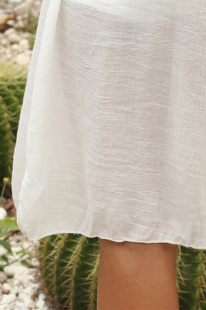 White crochet yoke cover-up dress with textured fabric and a scalloped hem.