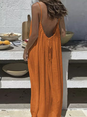 Orange backless maxi dress with spaghetti straps and drawstring detail.