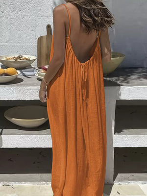Orange backless maxi dress with spaghetti straps and drawstring detail.