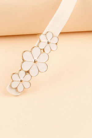 White skinny belt with gold trim and white floral blossom embellishments.