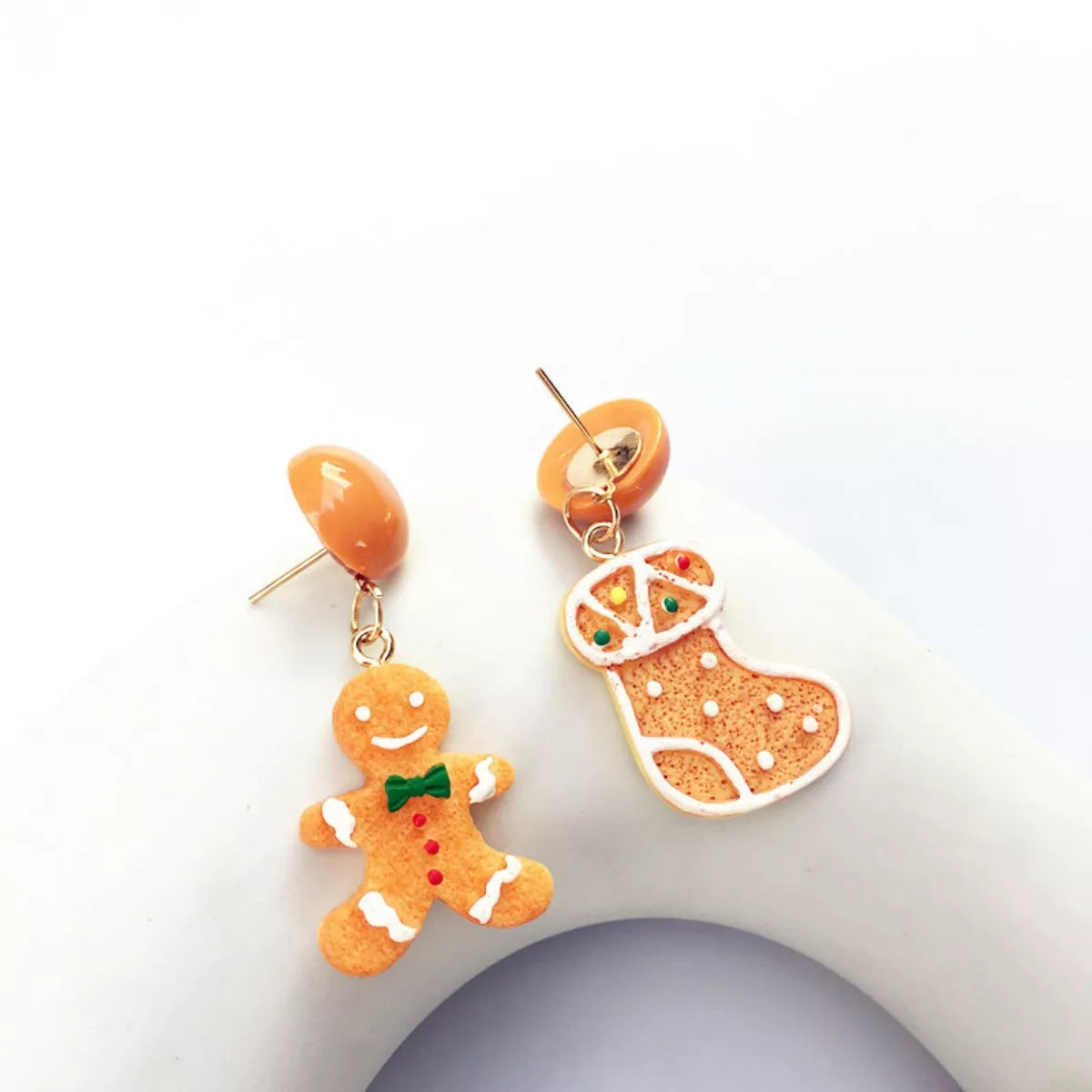 Gingerbread man and Christmas stocking dangle earrings with orange stud backs.