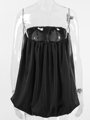 Black strapless bubble hem blouse with ruched bodice and thin straps.