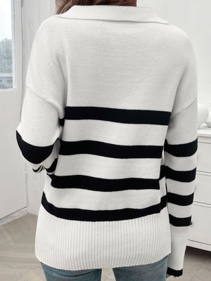 White and black striped knit polo sweater with a collar and ribbed hem.