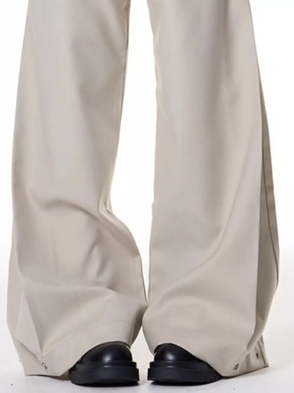 Men's beige wide-leg sweatpants with button details at the ankle.